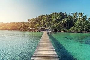 Images Dated 11th December 2017: Wooden jetty towards a small island in summer sea at Phuket, Thailand