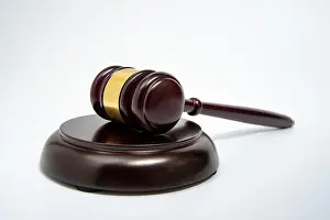 Judicial Prints: A wooden judge gavel isolated on white background