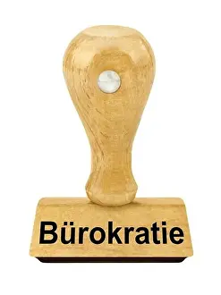 Bureau Prints: Wooden stamp and German Bureaucracy isolated against white background
