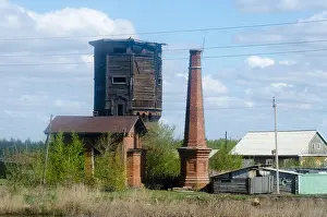 Water Tower Prints: Wooden water tower and brick chimney beside Trans Siberian Railway
