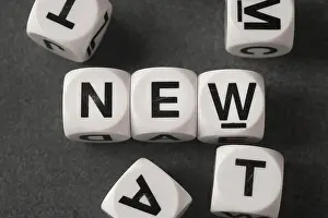 Progressive Prints: word new on white toy cubes