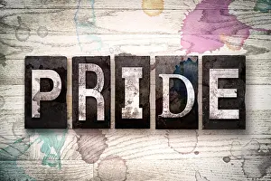 Glory Prints: The word 'PRIDE' written in vintage dirty metal letterpress type on a whitewashed wooden background with ink