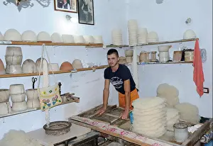 Albania Prints: A worker in a felt shop moulds the white brimless felt caps (qeleshe or plis) traditionally worn by Albanians