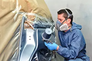 Paintwork Prints: Worker painting silver car in a paint box