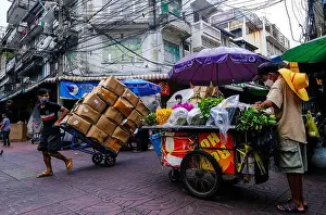 Thriving Prints: Workers and street vendors go about their daily business in Chinatown, Bangkok, Thailand