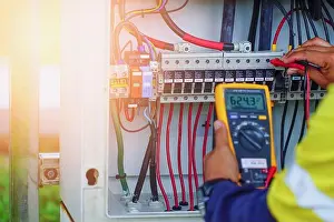 Repairman Prints: Workers use Multimeter to measure the voltage of electrical wires produced from solar energy for confirm to systems