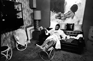Boxer Prints: After a workout, heavyweight champion 'Smokin' Joe Frazier rests in his dressing room/office at his gym