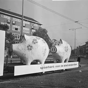 1965 Prints: World Savings Day Action. Two giant piggy banks on trailer with the text: Savings Bank for the city of Amsterdam saving