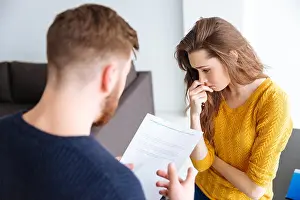 Argument Prints: Worried couple discussing about domestic finances at home
