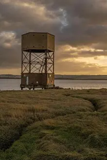 Portrait Format Prints: WW2 radar control building disguised as a water tower on the edge of the River Thames at Coalhouse Fort Essex at sunset