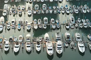 Yatch harbor marina pier and boat dock yatchs and vessels awaiting the open sea. Aerial drone view looking straight down above T-Head