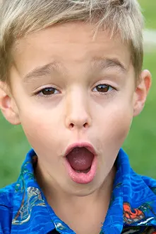 Comical Prints: Eight year old boy makes faces to the camera