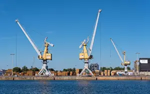 Blue Boat Prints: Three yellow cranes in the port of Saint-Malo on a beautiful blue sky