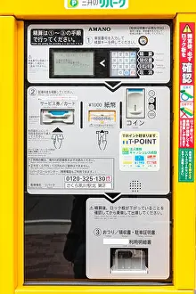 Car Park Prints: Yellow framed Japanese parking ticket machine with instructions in kanji and keypad.i