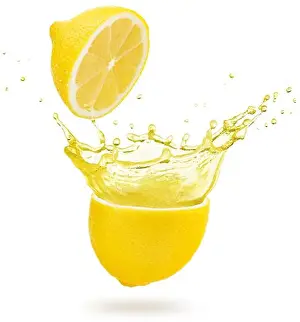 Spill Prints: yellow juice exploding out of a lemon isolated on white background