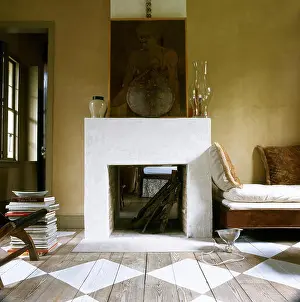 Fireplace Prints: Yellow sitting room with simple fireplace and painted floorboards