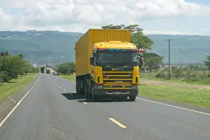 Rift Valley Prints: A yellow truck drives along the Old Naivasha road, Kenya, East Africa