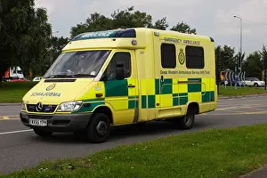Yellow UK ambulance at speed