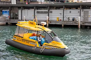 Sydney Harbour Prints: Yellow water taxi boat with skipper on the water at Circular Quay in Sydney, Australia