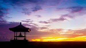 Lotus Position Prints: Yoga meditation outdoor under gazebo in full lotus position at the beach on sunrise or sunset