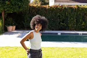 Dense Prints: Young African American woman standing on lawn in private backyard