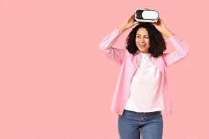 Reality Prints: Young African-American woman with VR glasses on pink background