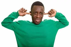 Loud Prints: Young African man covering ears with fingers