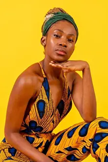 20 24 Years Prints: Young african woman with traditional costume on yellow background