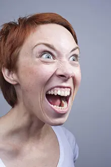 Redhead Prints: Young aggressive woman screaming