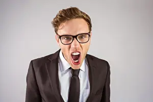 Well Dressed Prints: Young angry businessman shouting at camera