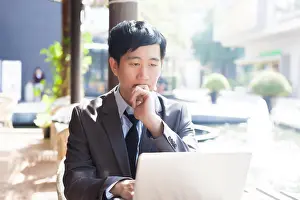 Necktie Prints: Young Asian casual businessman thinking while working in outdoor scene
