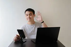 Wrist Prints: A young Asian man wearing a grey t-shirt