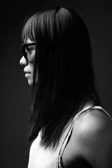 Eurasian Prints: Young Asian woman against gray background in black and white