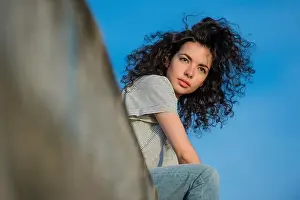 Moods Prints: A young attractive slim brunette woman girl with long wild curly brown hair