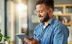 Lazy Prints: Young bachelor relaxing at home with his tablet