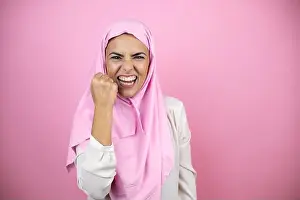 Braids Prints: Young beautiful arab woman wearing islamic hijab over isolated pink background angry