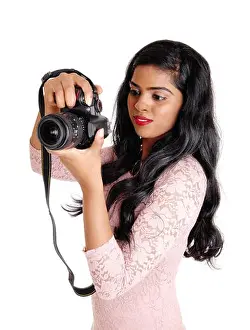 A young beautiful Indian women taking pictures with a DLS camera, isolated for white background