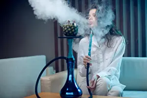 Vaping Prints: Young beautiful woman smokes hookah on tobacco with pineapple bowl