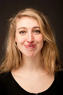 Adolescent Prints: a young blonde 19 year old teenage girl touching the tip of her nose with her tongue