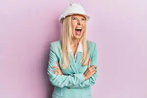 Hardhat Prints: Young blonde woman wearing architect hardhat angry and mad screaming frustrated and furious