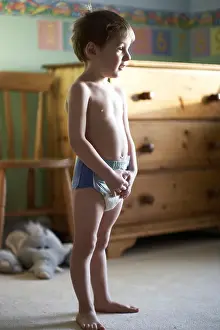 Carpets Prints: Young boy child standing in his bedroom wearing a pull up nappy CJWH