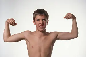 Brother Prints: Young boy flexs his muscles, USA