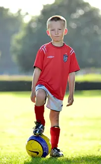 Released Prints: Young Boy Standing with Football