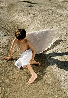 Childlike Prints: A young boy wearing angel wings