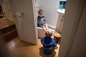 Young brothers simultaneously toilet and potty training together at home, UK