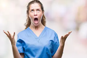 Curly Hair Prints: Young brunette doctor girl wearing nurse or surgeon uniform over isolated background crazy and mad shouting