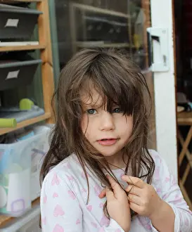 Young Girl Prints: Young Brunette girl with messy brown hair in her pyjamas and chocolate around mouth