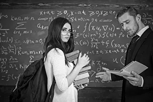 Bristle Prints: Young brunette in pink cardigan wearing glasses holding heap of books while professor is reading