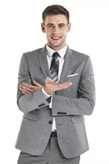 Presenting Prints: Young business man use hand to hold something isolated on white background