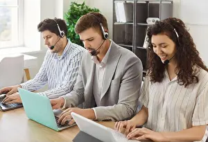 Representative Prints: Young business people sitting in a row working in call center at online support service office